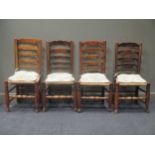 A set of four 19th century ladder back dining chairs with rush seats