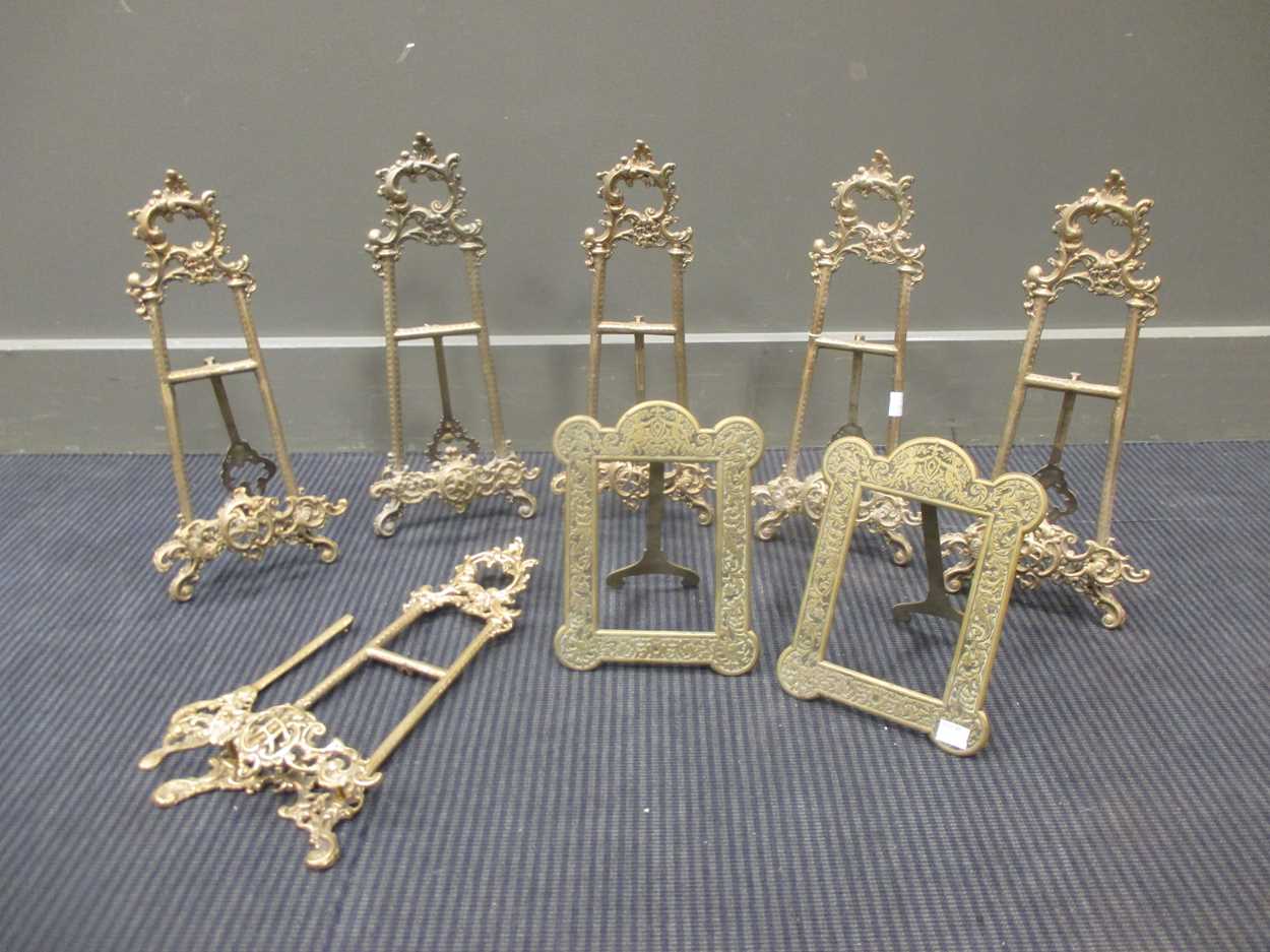 A set of six brass photograph stands, together with a pair of brass photograph frames (8)