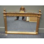 A Regency style gilt wood rectangular over mantel mirror, with spread eagle cresting flanked by urns