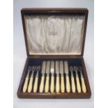 A cased set of Victorian silver fruit eaters, the knives with silver blades, together with a cased