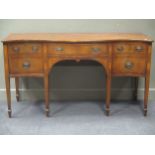 A late 19th century mahogany serpentine front sideboard, inlaid with patera and crossbanded drawer