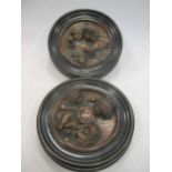 A pair of pressed metal roundels of children, after Joshua Reynolds and Thomas Lawrence, frame