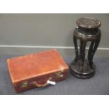A leather suitcase and a Japanese lacquered urn or jardiniere stand