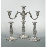 An American silver plated three light candelabra together with a matching pair of candlesticks,