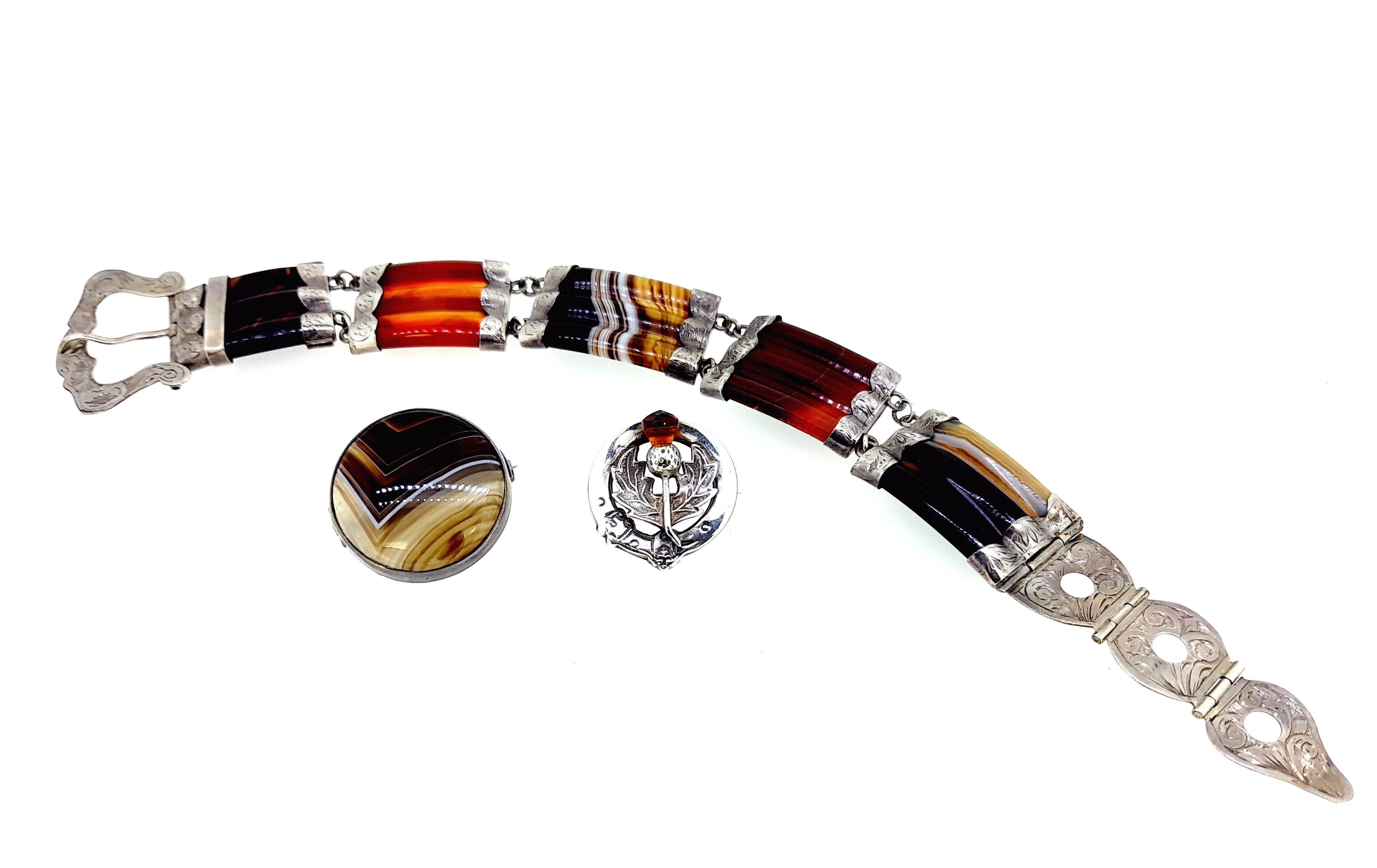 An agate bracelet and two brooches in the Scottish style,