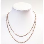 A rose coloured fancy link long guard chain,