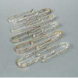 Ten pairs of George III 18th century cast silver sugar tongs,