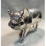 A modern and realistic silver model of a boar,