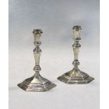 A pair of 20th century cast silver taper sticks,