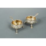 A pair of George II silver cauldron salts with later spoons,