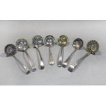 Three George III 18th century silver sugar sifting spoons together with four Victorian examples,