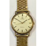 Omega - A gentleman's 9ct gold 'Geneve' wristwatch on a 9ct gold bracelet,