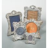 Four early 20th century silver easel back photograph frames together with a later example,