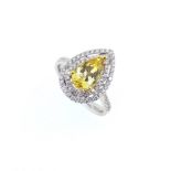 A golden beryl and diamond halo style ring,