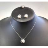 A three piece suite of pearl and diamond jewellery,