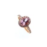A morganite and diamond halo style cluster ring,