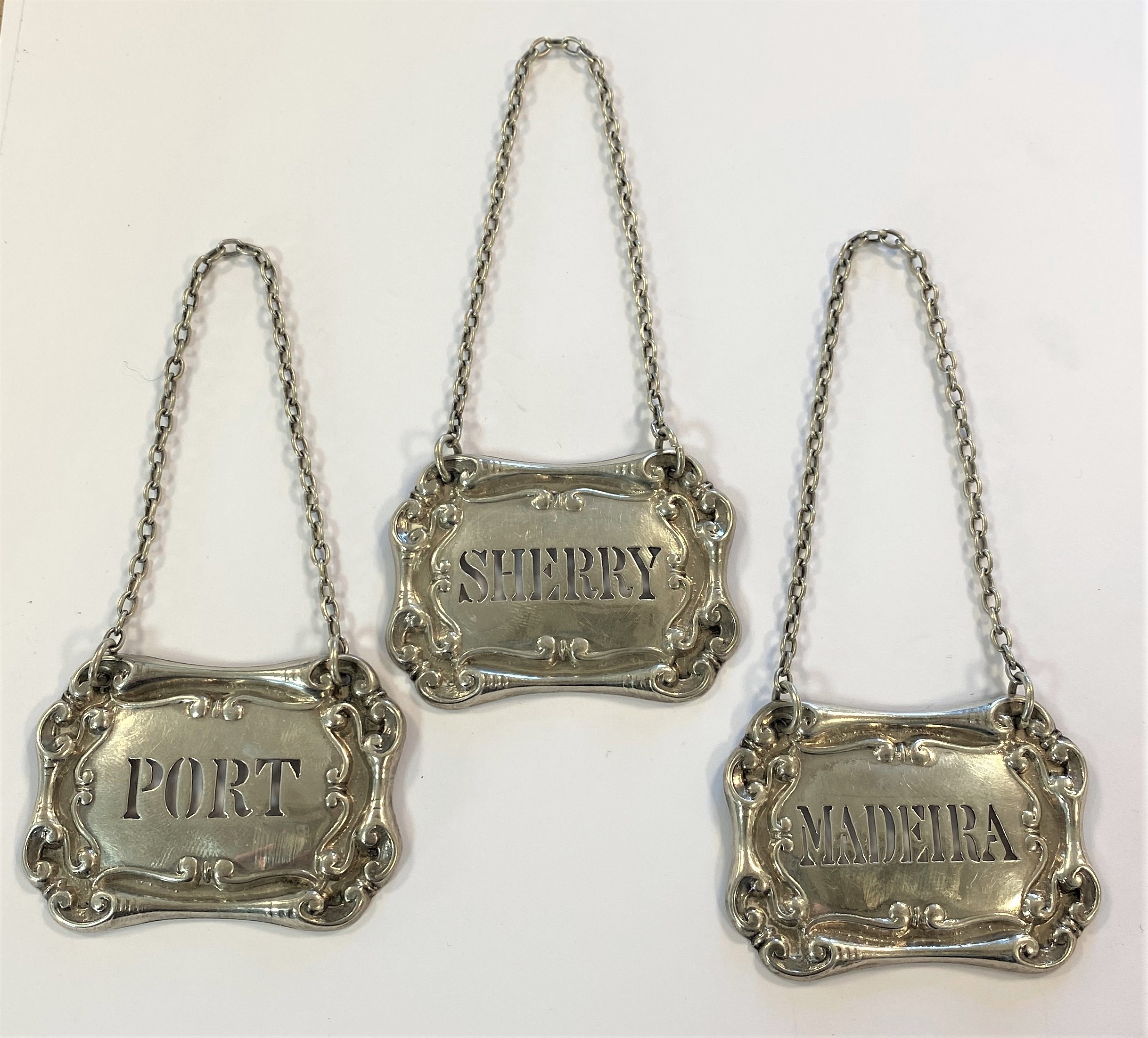 A trio of Edward VII silver decanter labels,