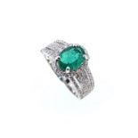 A modern style emerald and diamond cluster ring,