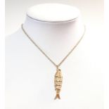 An articulated fish pendant and chain,