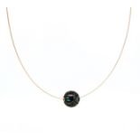 A carved Tahitian cultured pearl pendant with turquoise bead interior and wire,