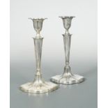 A pair of George V silver candlesticks,