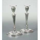 A pair of George V silver candlesticks,