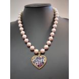 A multi-coloured sapphire and diamond set heart pendant on an edison pearl necklace,