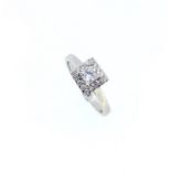 A cluster ring with a princess cut diamond centre,