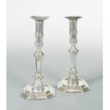 A pair of continental metalwares cast candlesticks,