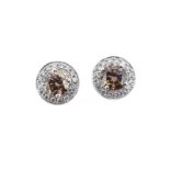 A pair of fancy brown and white diamond halo style cluster ear studs,