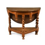 A 17th century style oak three-legged drop flap table,