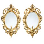 A pair of carved giltwood and gesso three light girandoles, circa 1875,