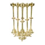 A set of six early 20th century gothic revival brass candlesticks,