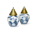 A pair of Delft blue and white tobacco jars and covers,