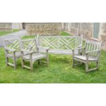 A weathered garden bench and a pair of arm chairs, late 20th century,