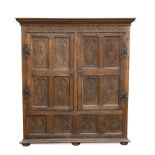 A carved oak panelled livery cupboard, 19th century,