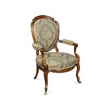 An early Victorian carved walnut open armchair,