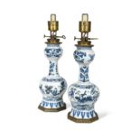 A pair of Delft blue and white gilt metal mounted lamps,