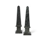 A near pair of black marble obelisks,