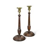 A pair of turned and carved columnar candlesticks,