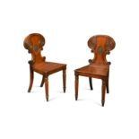 A pair of late Regency mahogany armorial hall chairs,