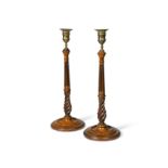 A pair of George III brass and mahogany candlesticks,