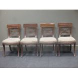 A set of four 19th Century mahogany dining chairs with sabre legs in the manner of Thomas Hope