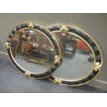 A pair of Christopher Guy oval wall mirrors, 112 x 92cm