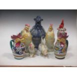 Collection of model china cockerells and a German stoneware rotund figural jug (8)