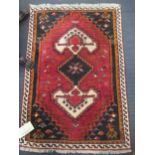 A red ground rug with single medalion together with another rug, 118 x 71cm and 110 x 72cm (2)