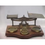 A set of brass and oak postage scales, circa 1900