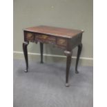 An 18th century carved oak lowboy, the pinched corner three plank top over three drawers on cabriole