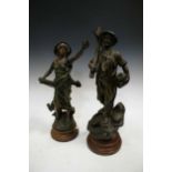 A pair of spelter figures of land workers, 50cm high and a near pair of similar spelter figures (4)