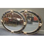 A pair of Christopher Guy oval wall mirrors, 112 x 92cm